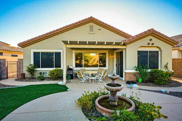 a front view of a house with porch and garden