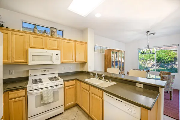 a kitchen that has a sink and a stove in it