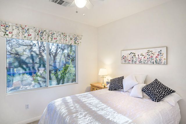 a bedroom with a bed and a painting on the wall