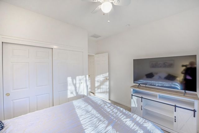 a bedroom with a bed and a chandelier