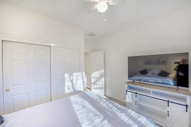 a bedroom with a bed and a chandelier