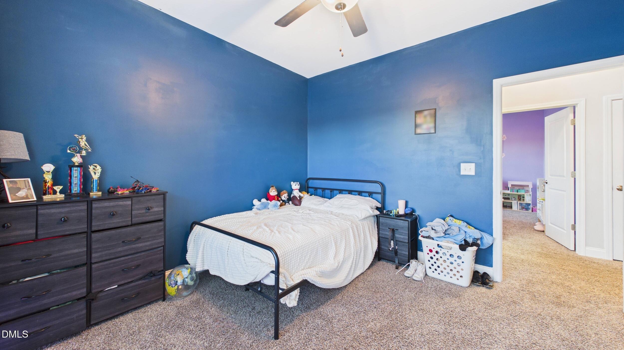5930 Old 421 Road Liberty, NC 27298 - Photo 25 of 42 a bedroom with a bed and a chandelier