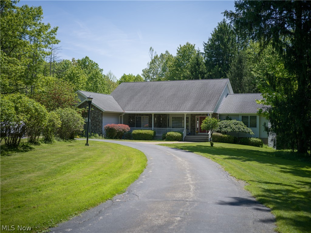 8745 Broadview Road Broadview Heights, OH 44147 - Photo 35 of 49 Ranch-style residence featuring a paved driveway, stone accents, a covered front porch, and mature landscaping