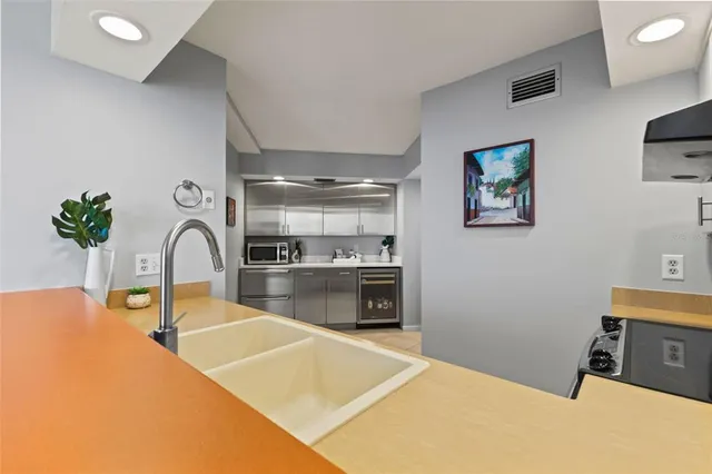 a kitchen with stainless steel appliances granite countertop a sink and cabinets