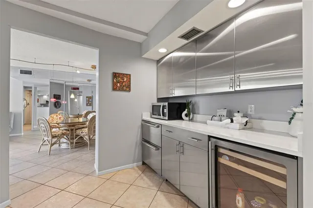 a kitchen with stainless steel appliances granite countertop a refrigerator and a stove