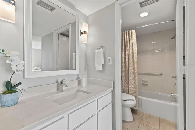 a bathroom with a shower curtain and a sink