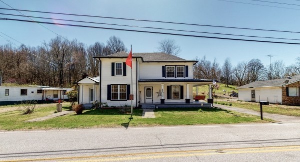 a front view of a house with a garden and plants