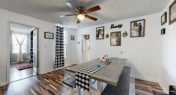a view of a workspace with furniture and a bookshelf