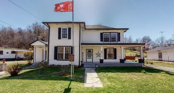 a front view of a house with garden