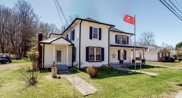 a front view of house with yard and green space