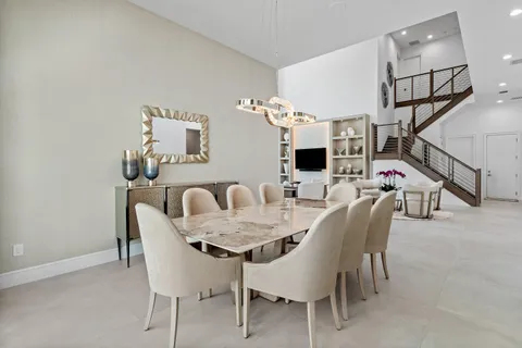 a view of a dining room with furniture and chandelier