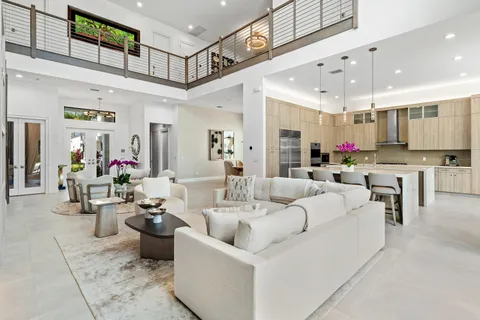 a kitchen with stainless steel appliances granite countertop a sink dishwasher a stove and white cabinets with wooden floor
