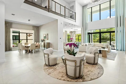 a dining room with furniture a chandelier and a rug