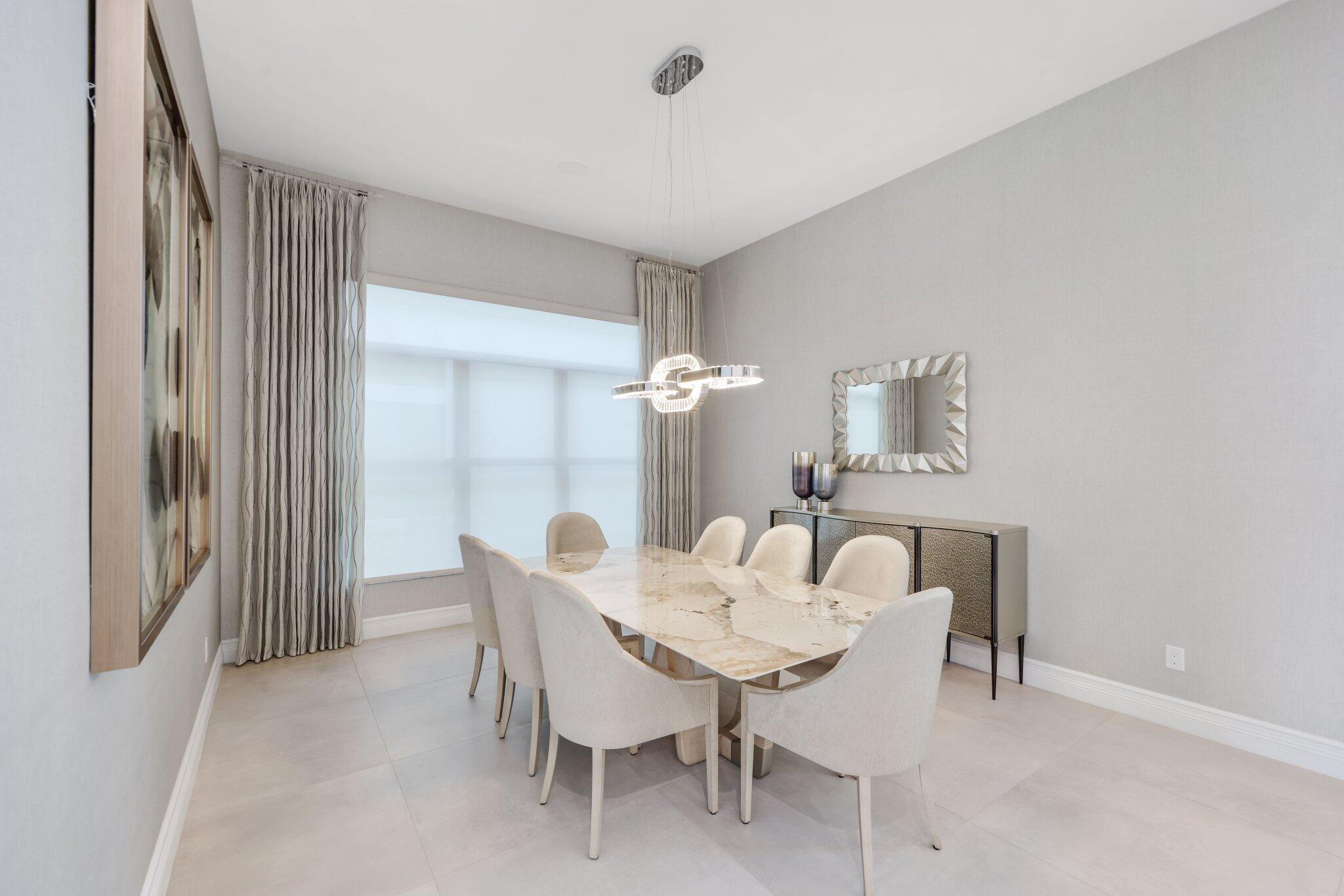 17432 Ponte Chiasso Drive Boca Raton, FL 33496 - Photo 19 of 116 a view of a dining room with furniture and chandelier