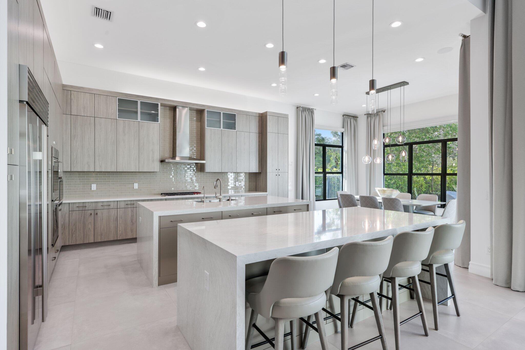17432 Ponte Chiasso Drive Boca Raton, FL 33496 - Photo 21 of 117 a large kitchen with kitchen island a table and chairs in it