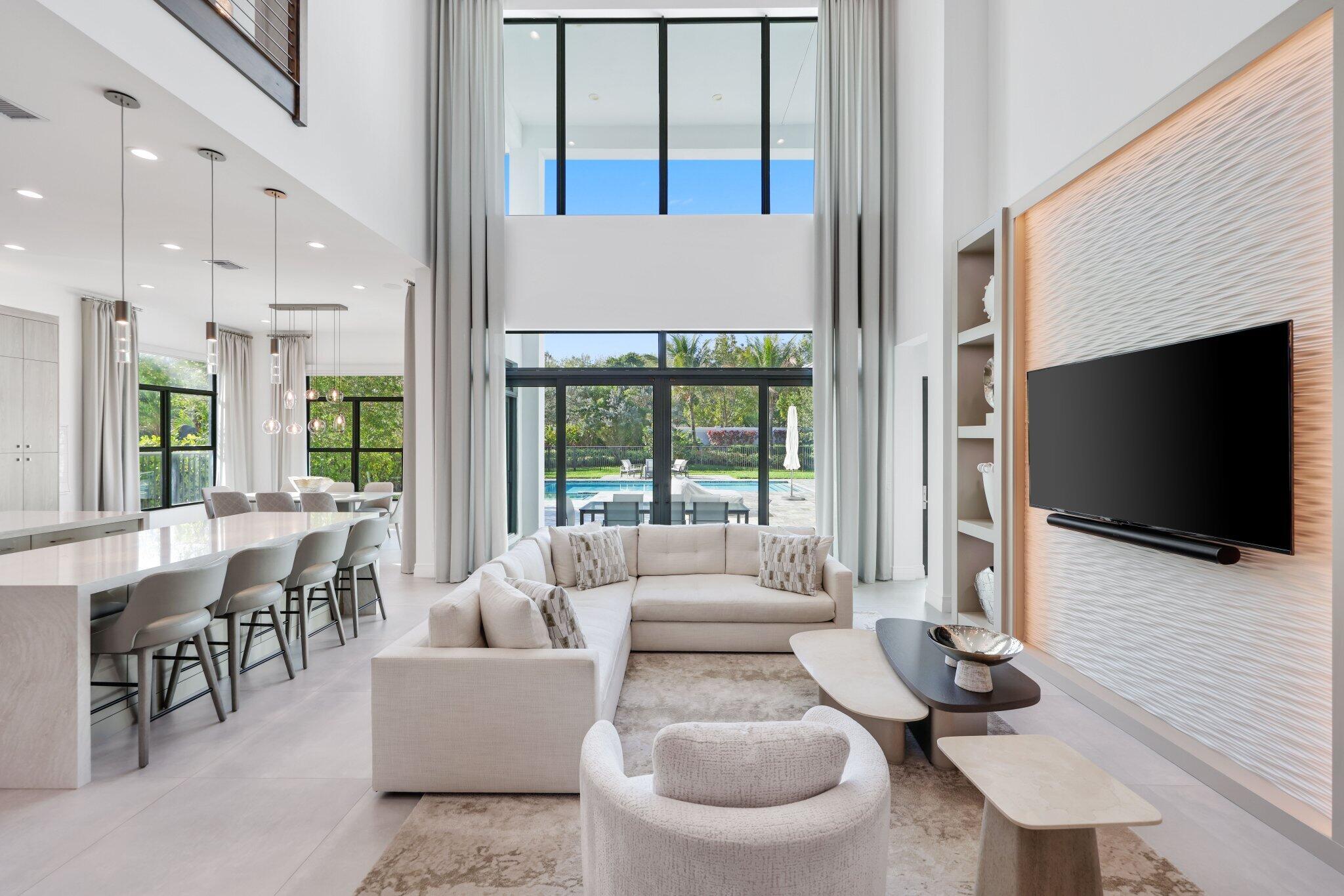 17432 Ponte Chiasso Drive Boca Raton, FL 33496 - Photo 22 of 116 a living room with furniture a flat screen tv and a large window