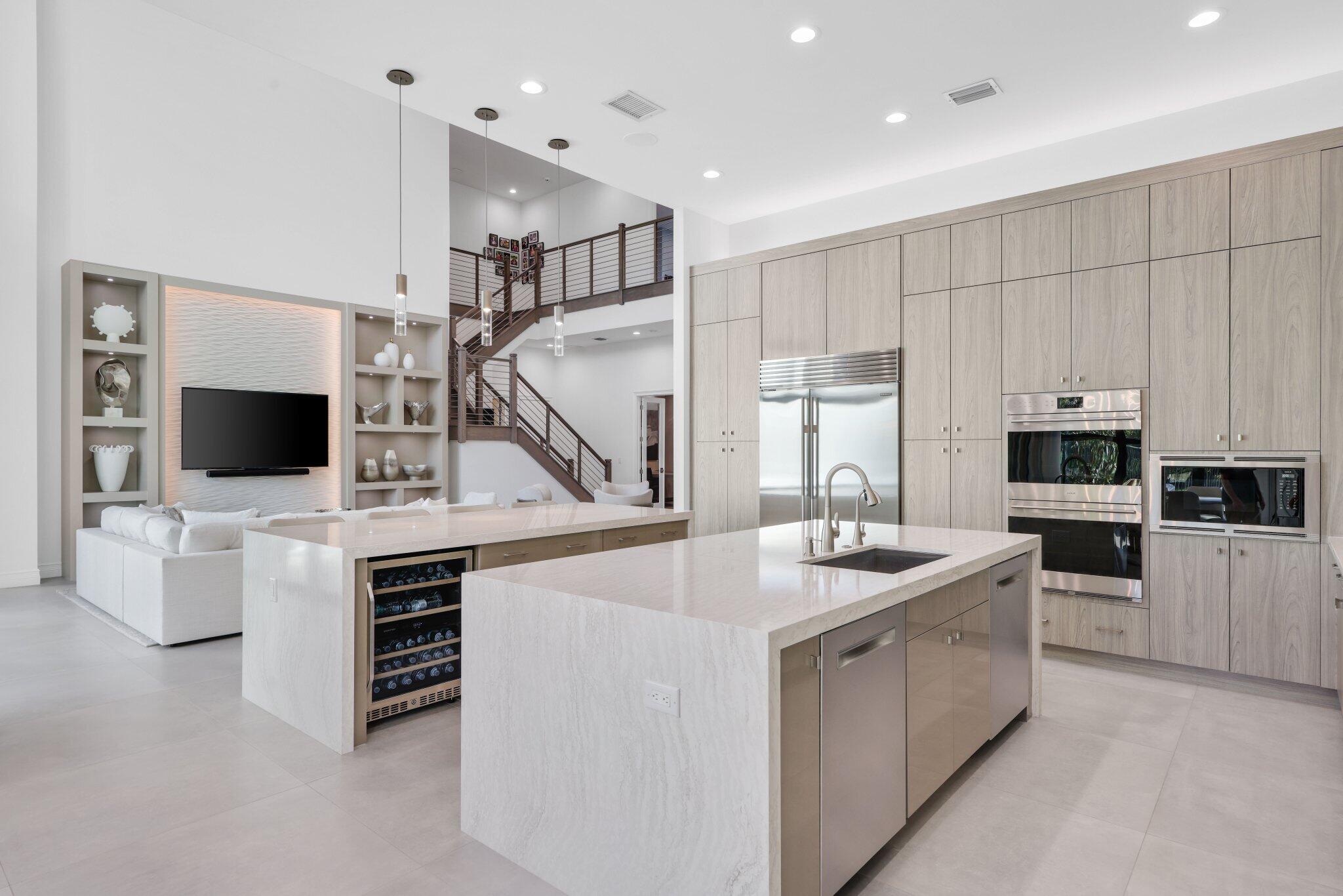 17432 Ponte Chiasso Drive Boca Raton, FL 33496 - Photo 26 of 117 a kitchen with kitchen island white cabinets and stainless steel appliances