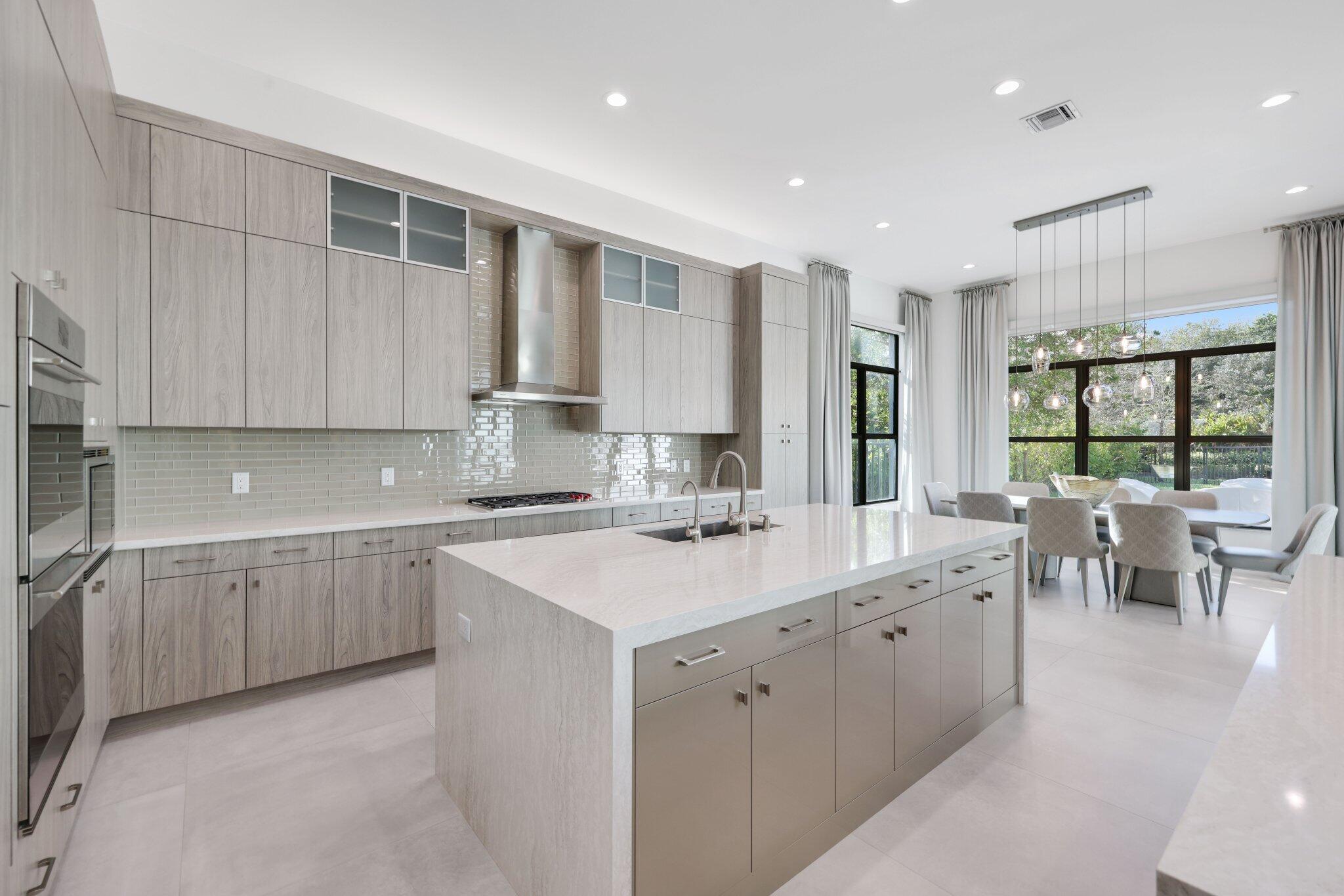 17432 Ponte Chiasso Drive Boca Raton, FL 33496 - Photo 28 of 117 a kitchen with a sink stove and cabinets