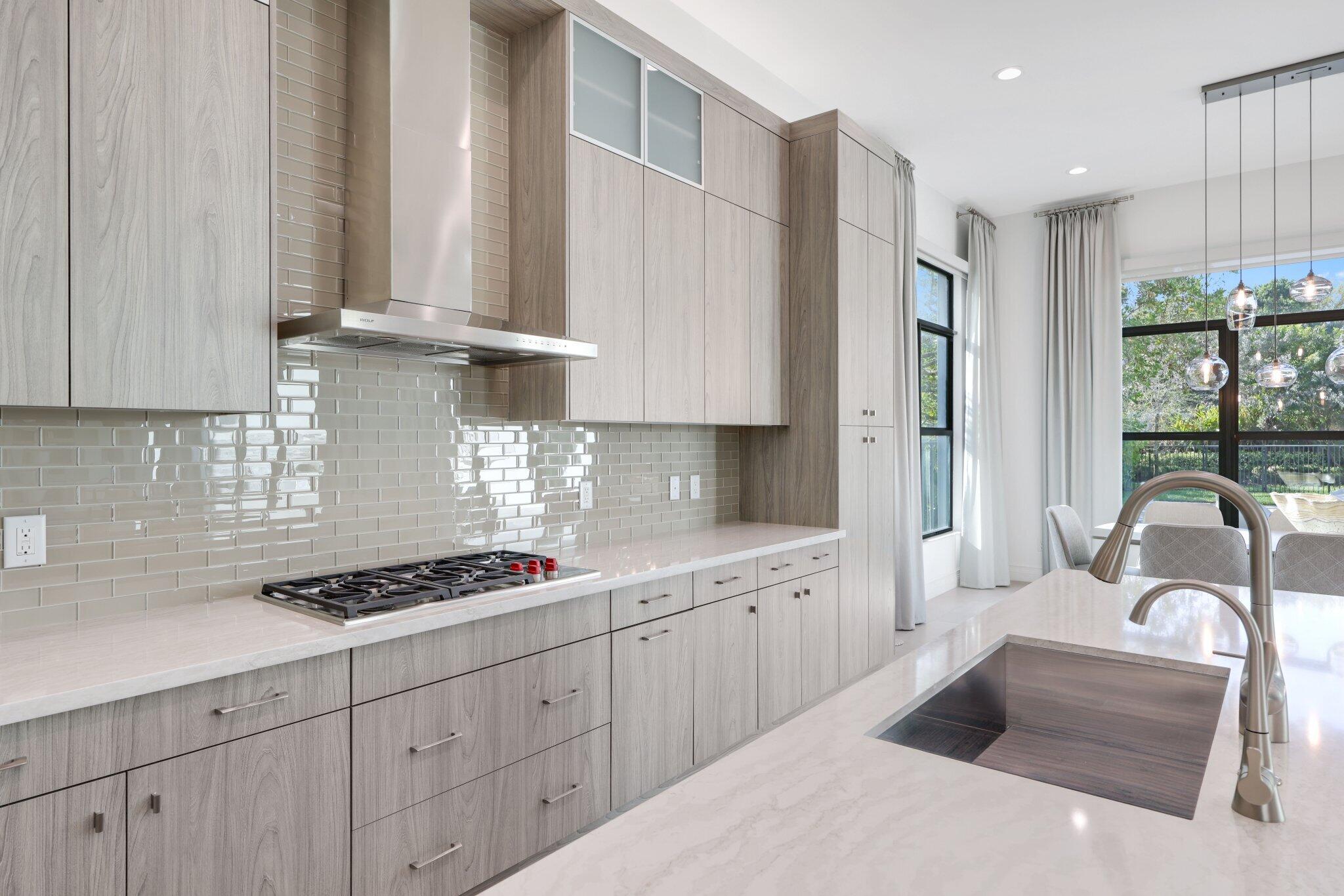 17432 Ponte Chiasso Drive Boca Raton, FL 33496 - Photo 30 of 117 a kitchen with stainless steel appliances granite countertop a sink dishwasher a stove and white cabinets with wooden floor