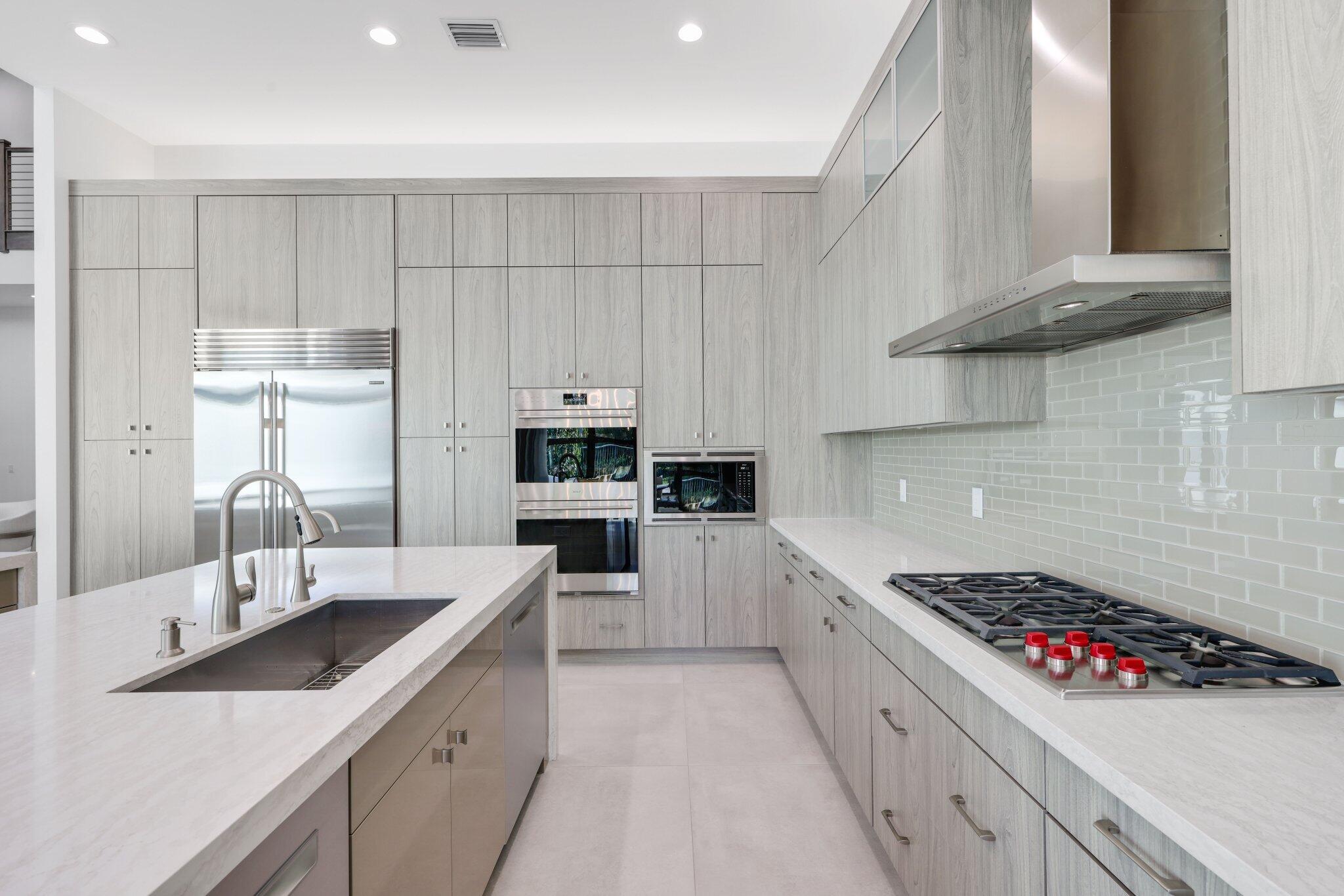 17432 Ponte Chiasso Drive Boca Raton, FL 33496 - Photo 32 of 117 a kitchen with white cabinets and appliances