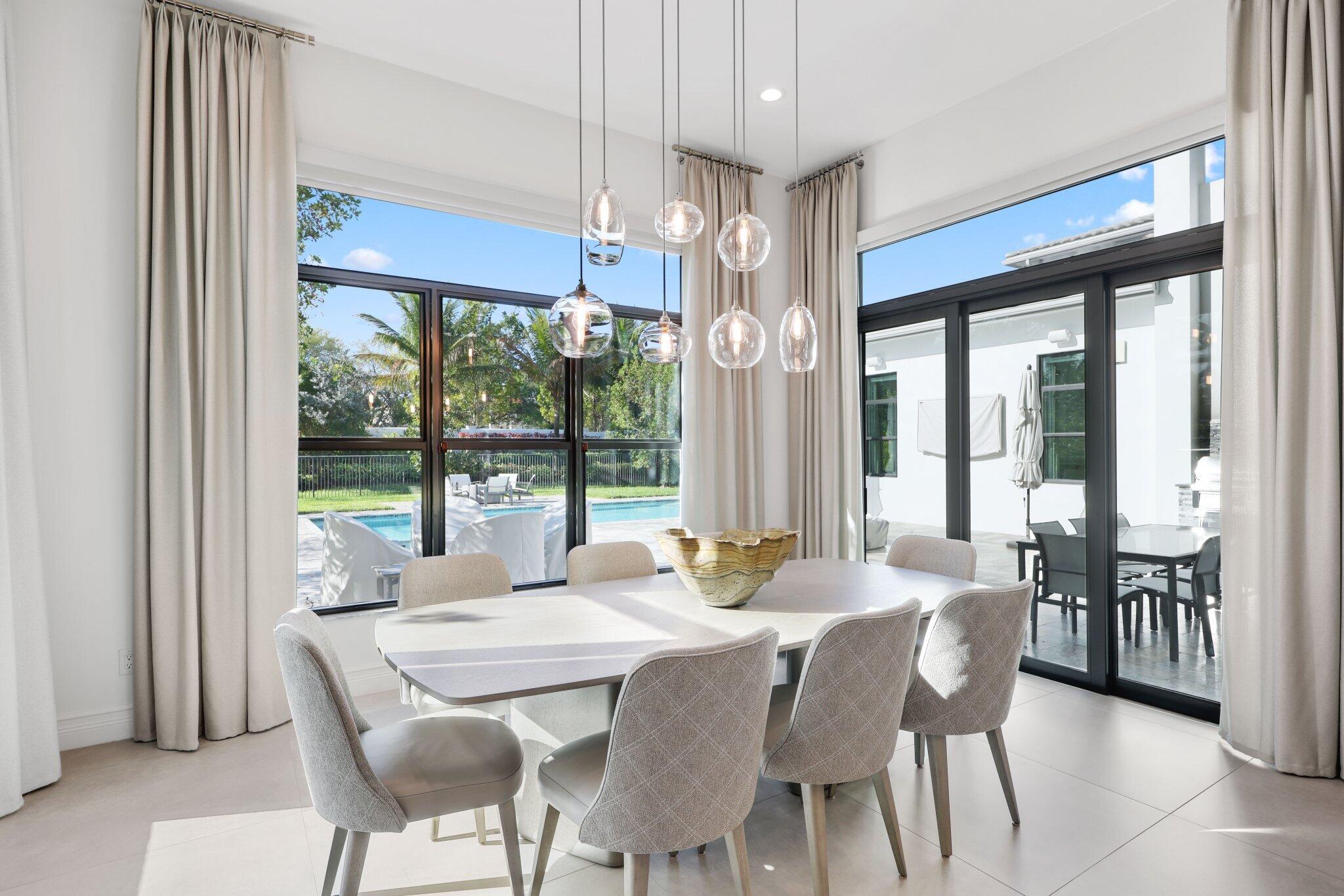 17432 Ponte Chiasso Drive Boca Raton, FL 33496 - Photo 33 of 116 a dining room with furniture a chandelier and a rug