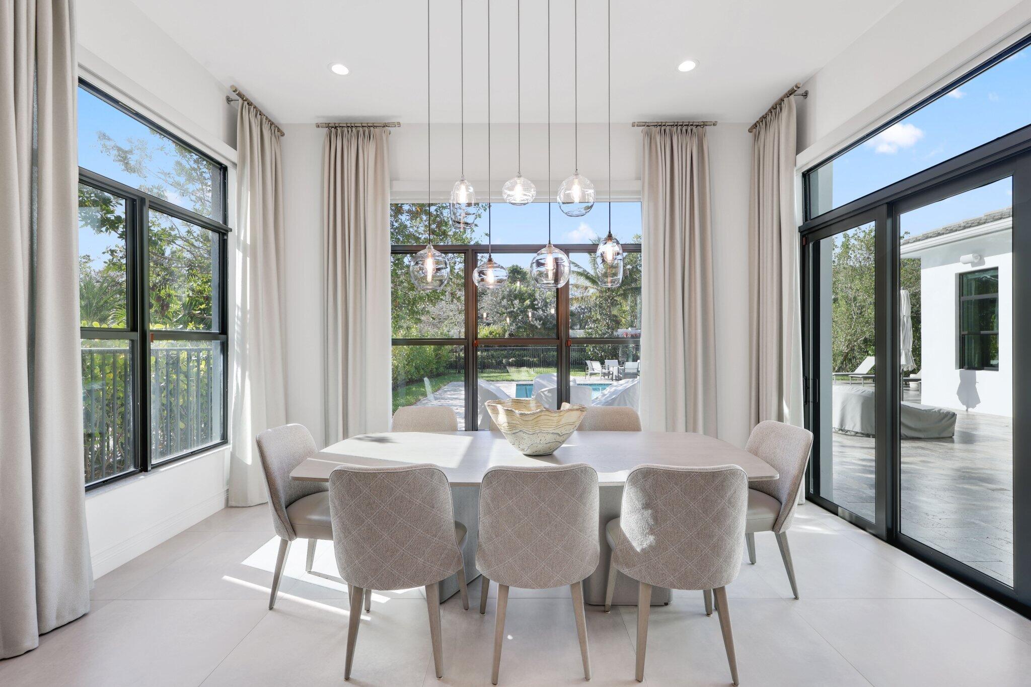 17432 Ponte Chiasso Drive Boca Raton, FL 33496 - Photo 34 of 117 a view of a dining room with furniture large windows and wooden floor