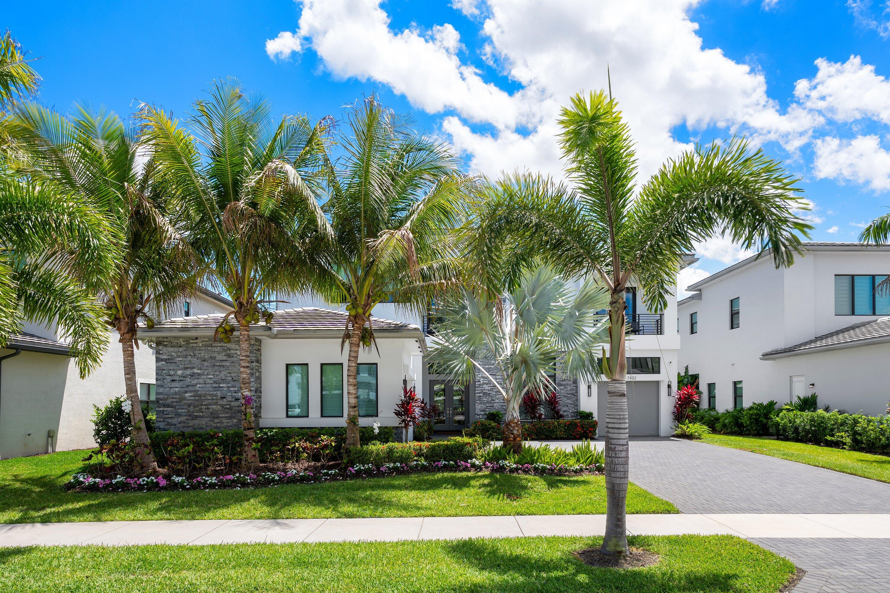 17432 Ponte Chiasso Drive Boca Raton, FL 33496 - Photo 4 of 116 a front view of a house with a yard and palm trees