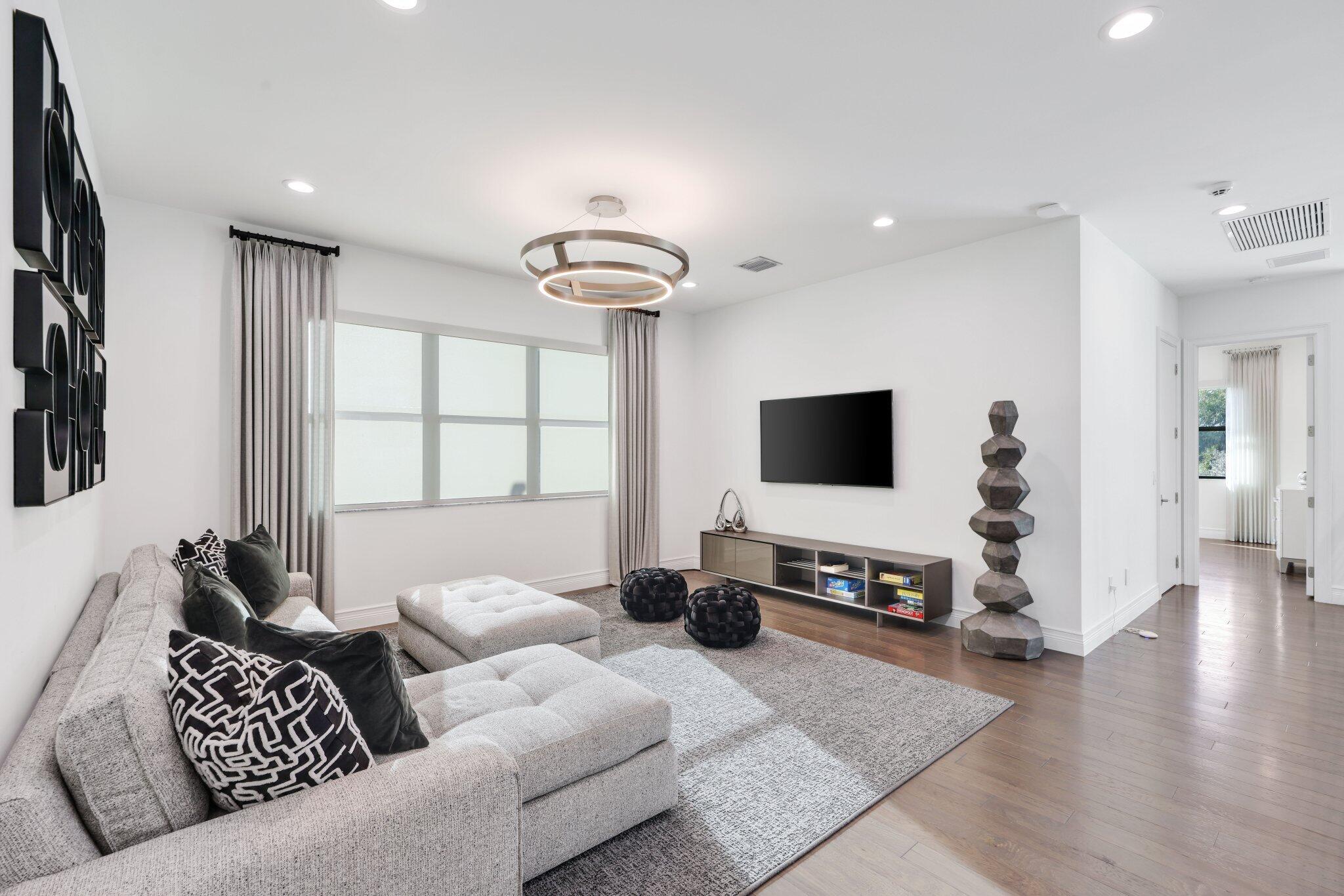 17432 Ponte Chiasso Drive Boca Raton, FL 33496 - Photo 48 of 116 a living room with furniture and a flat screen tv