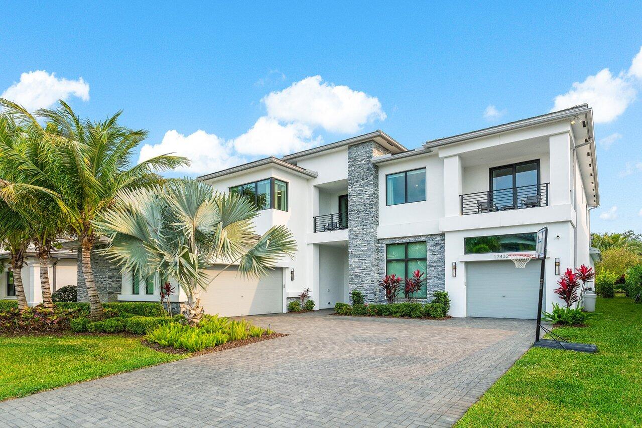 17432 Ponte Chiasso Drive Boca Raton, FL 33496 - Photo 58 of 116 a front view of a house with a garden and plants