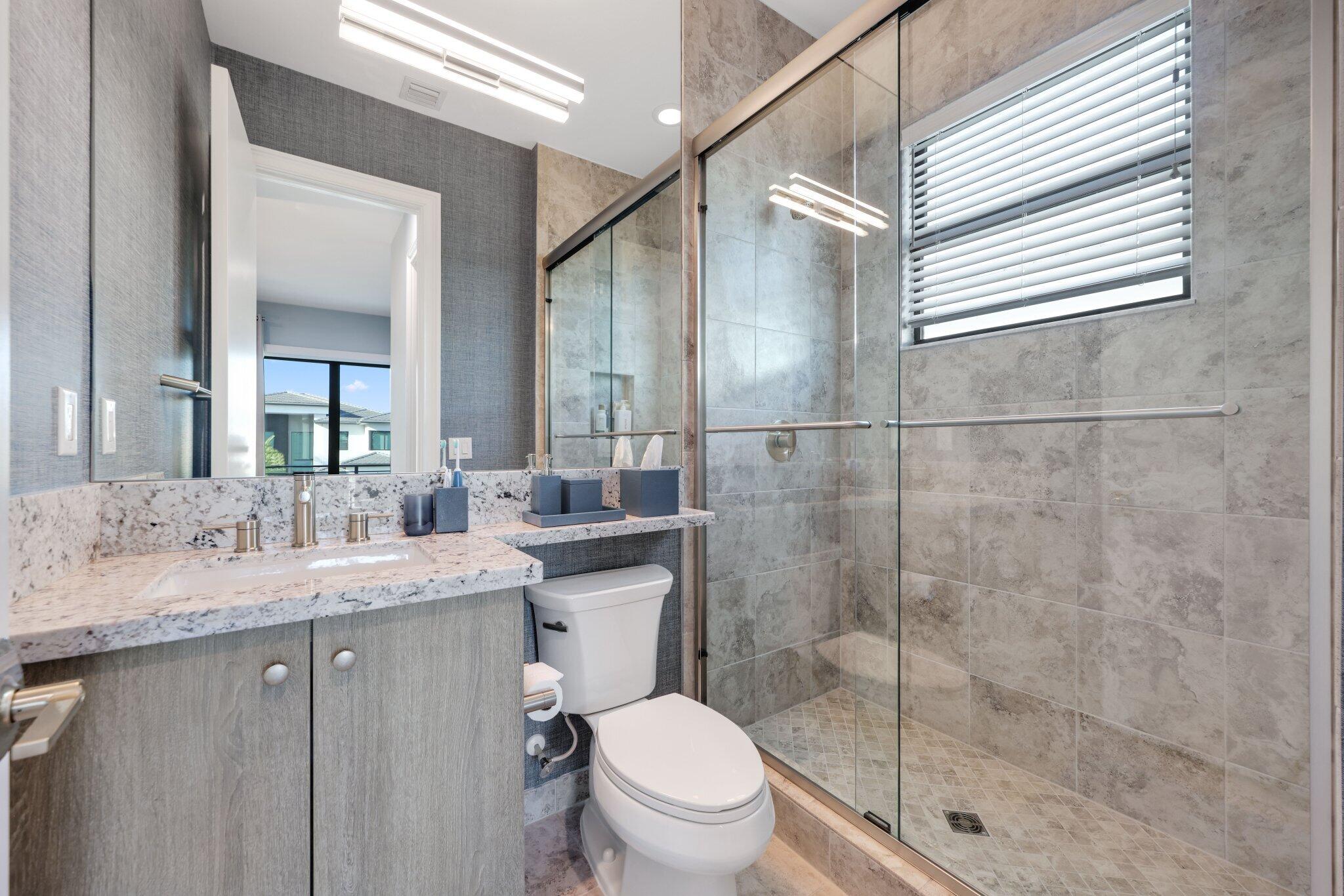 17432 Ponte Chiasso Drive Boca Raton, FL 33496 - Photo 61 of 117 a bathroom with a granite countertop sink toilet and shower