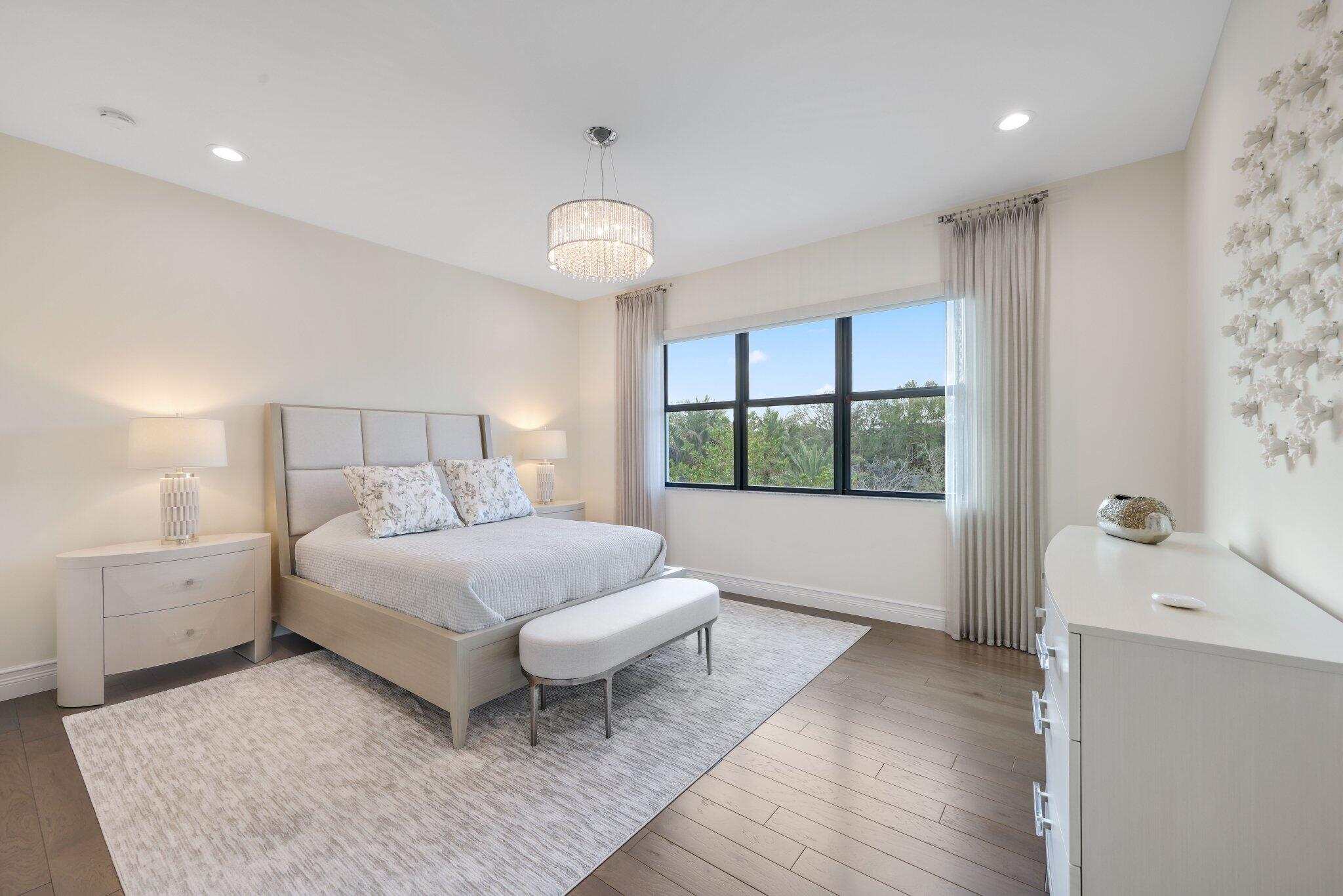 17432 Ponte Chiasso Drive Boca Raton, FL 33496 - Photo 63 of 117 a bedroom with a large bed and a window