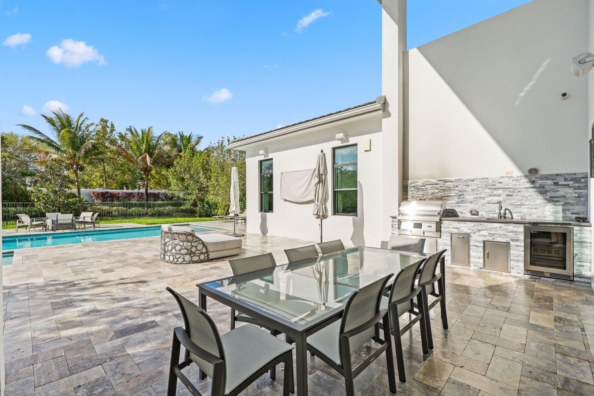 17432 Ponte Chiasso Drive Boca Raton, FL 33496 - Photo 77 of 117 a view of an outdoor dining space with furniture and wooden floor