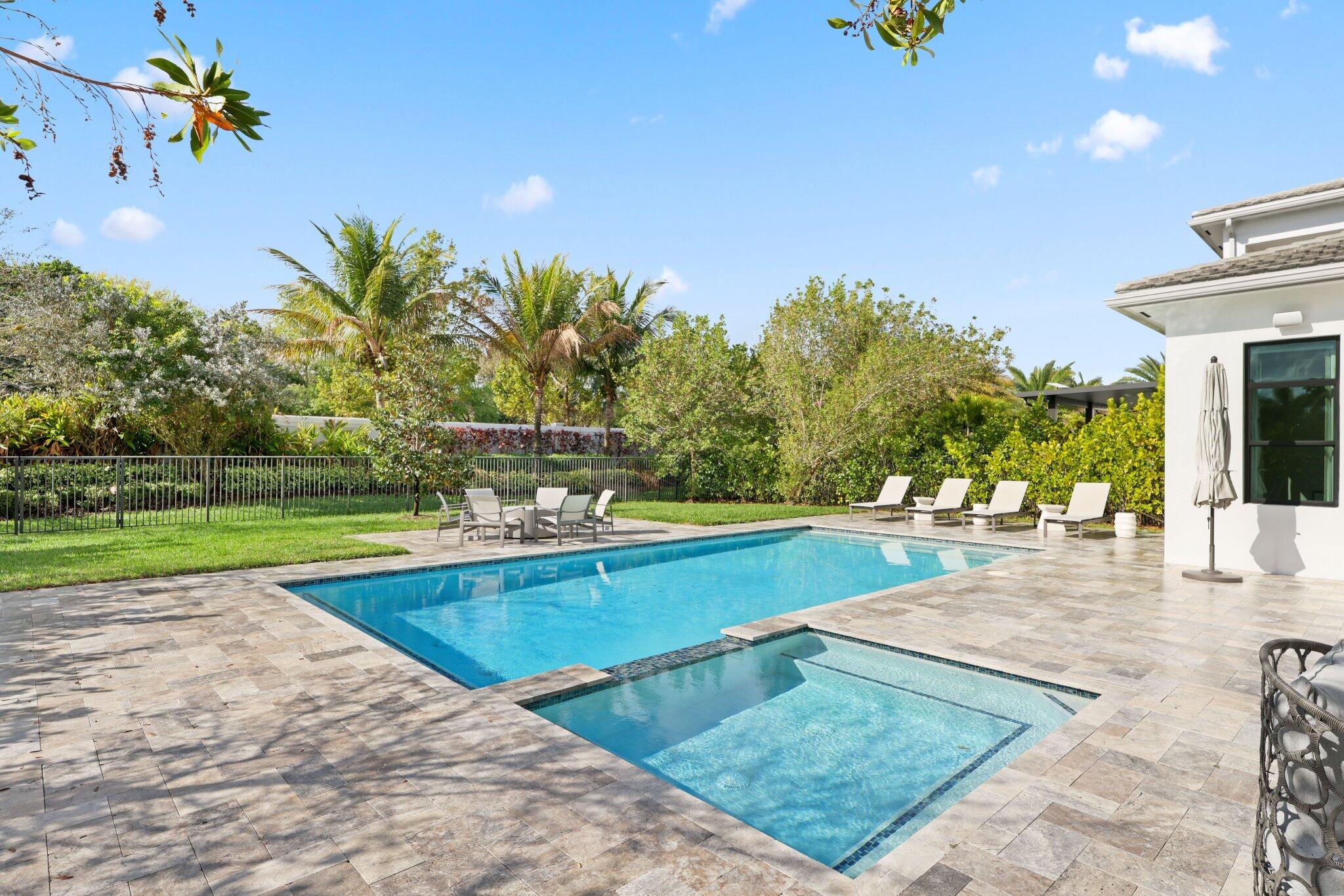 17432 Ponte Chiasso Drive Boca Raton, FL 33496 - Photo 86 of 117 a view of a swimming pool with an outdoor space and seating area
