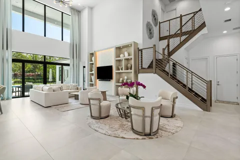 a dining room with furniture a large window and a rug