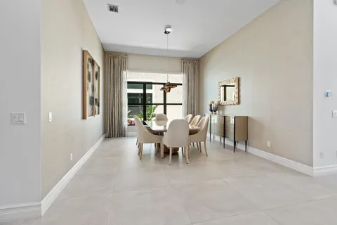 a view of a dining room with furniture and a window