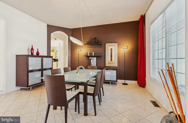 a large kitchen with stainless steel appliances a stove a sink and a living room view