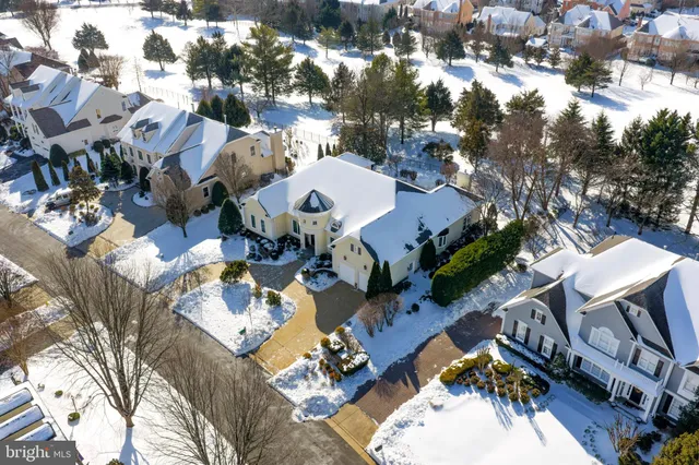 a view of a white house with a yard and sitting area
