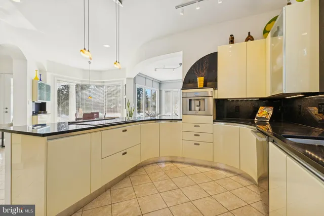 a view of staircase with lots of frames on wall and a book shelf