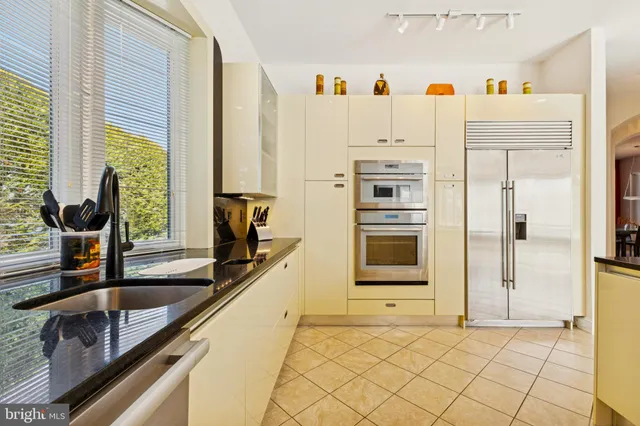 a kitchen with a refrigerator and table chair
