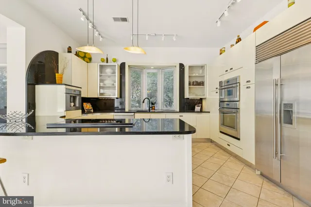 a view of a room with a table and chairs