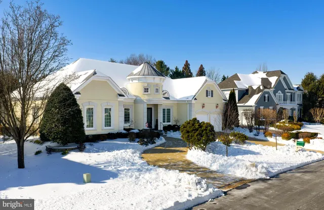 a view of a swimming pool with a lawn chairs and a small yard