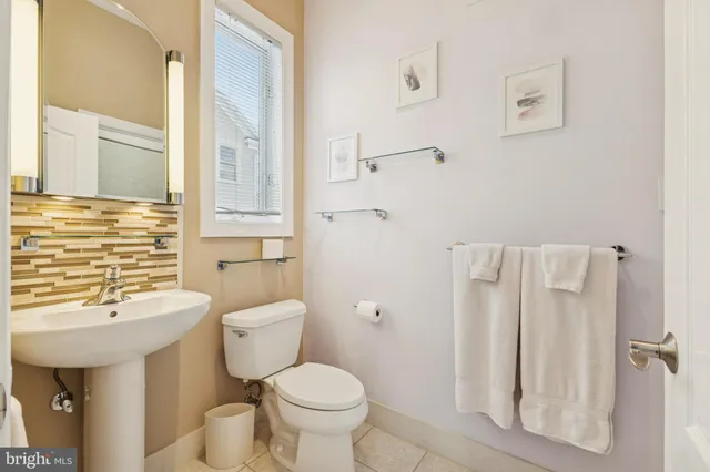 a view of a white house with a swimming pool and sitting area