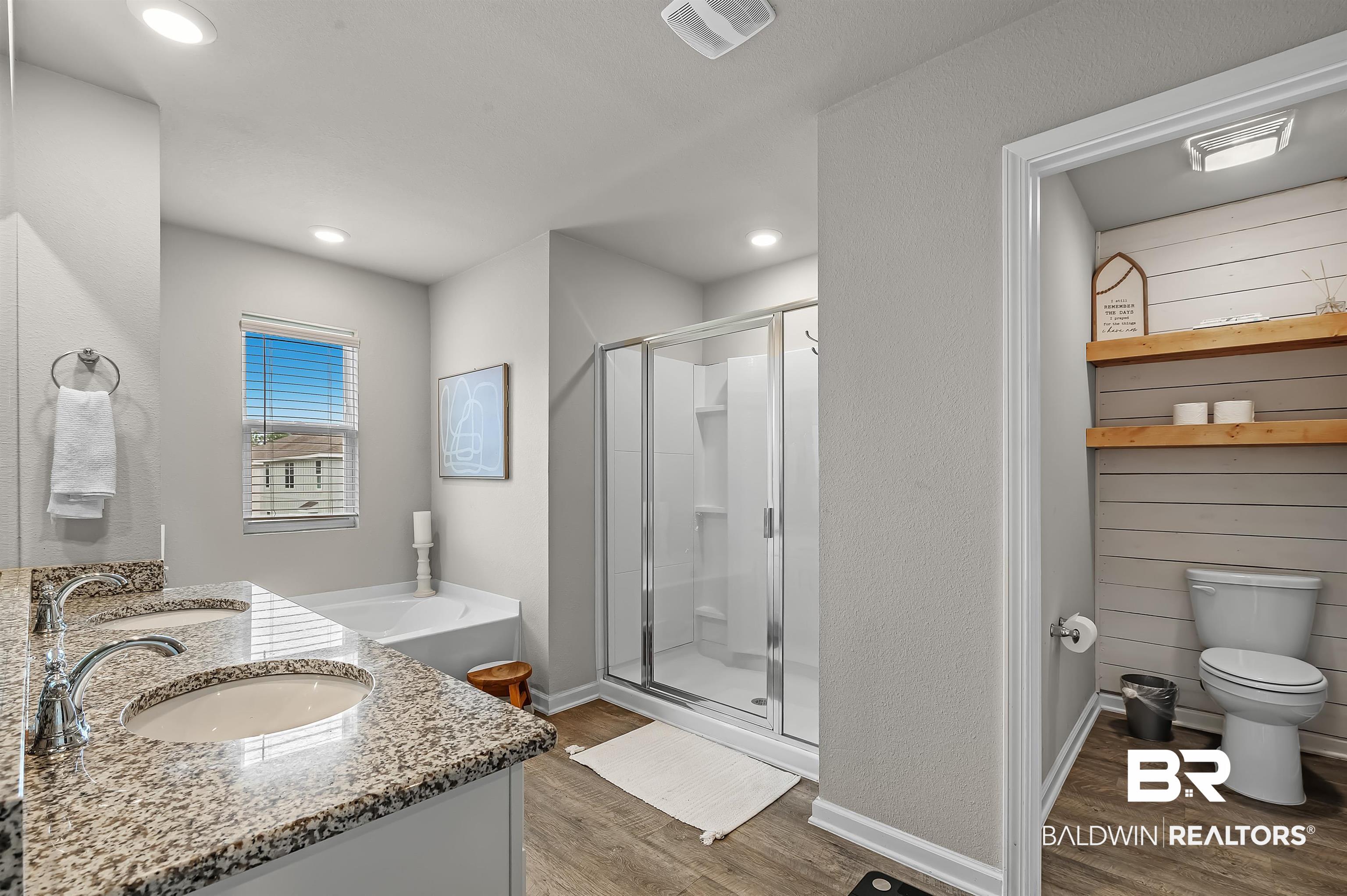 24549 Broken Sound Loop Orange Beach, AL 36561 - Photo 30 of 57 Full bathroom with hardwood / wood-style flooring, vanity, separate shower and tub, and toilet