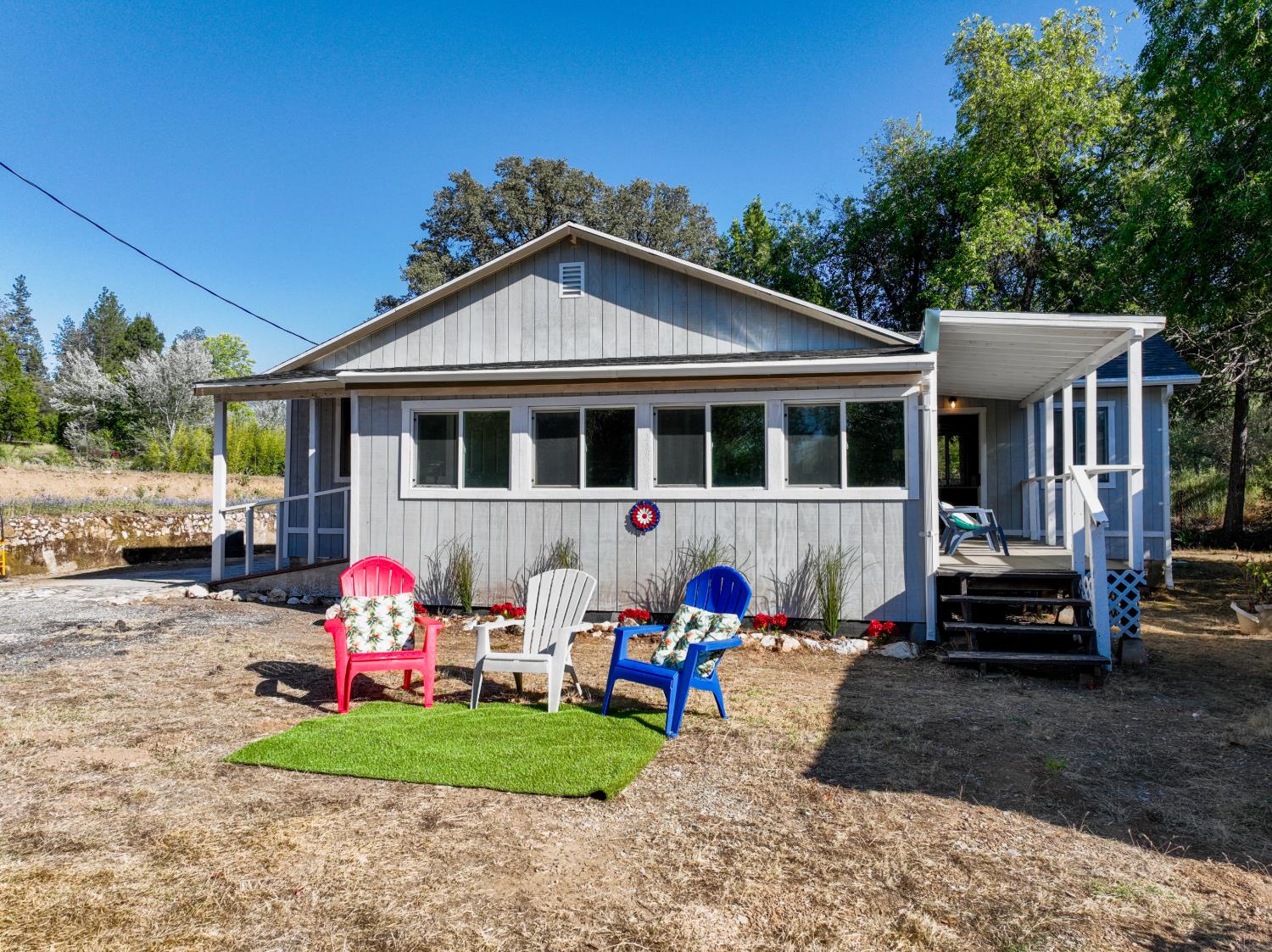 13351 Newtown Road Nevada City, CA 95959 - Photo 20 of 50 a front view of a house with a yard table and chairs