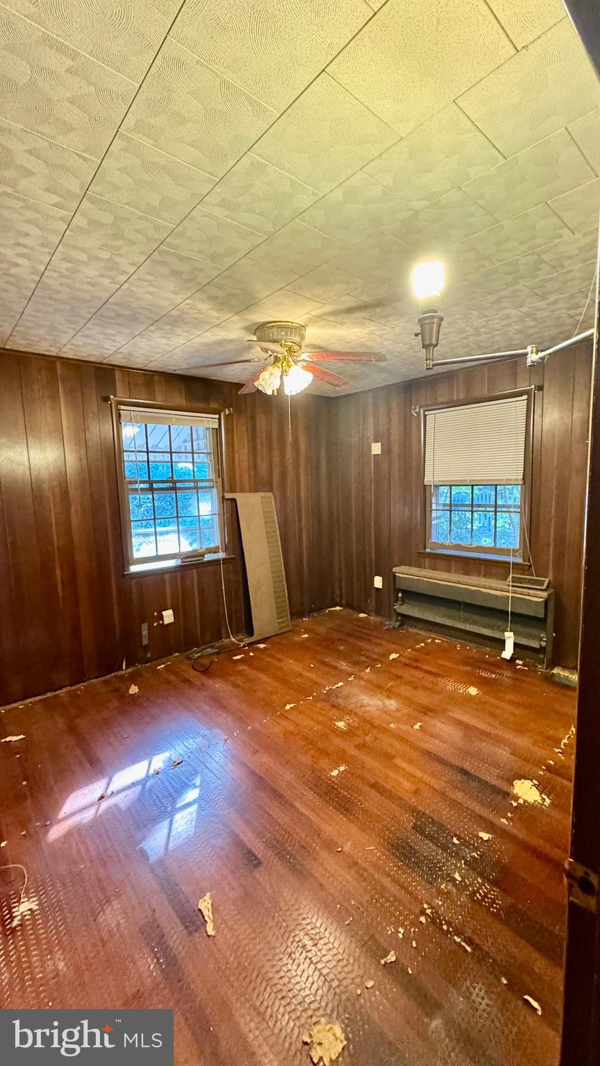1 Potomac Street Crisfield, MD 21817 - Photo 7 of 15 a view of an empty room with window and wooden floor