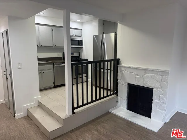 a kitchen with stainless steel appliances a refrigerator and a stove top oven