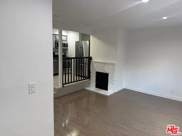 a view of empty room with fireplace