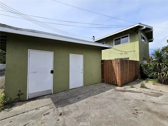 a front view of a house with a wooden fence