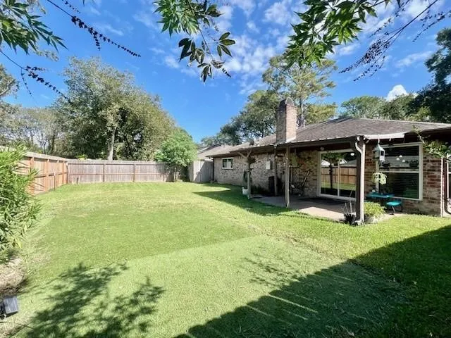 a view of a house with a yard and sitting area