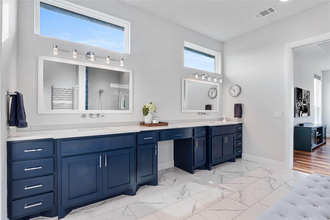 504 Loyal June Trail Leander, TX 78641 - Photo 14 of 16 a bathroom with a tub sink and mirror